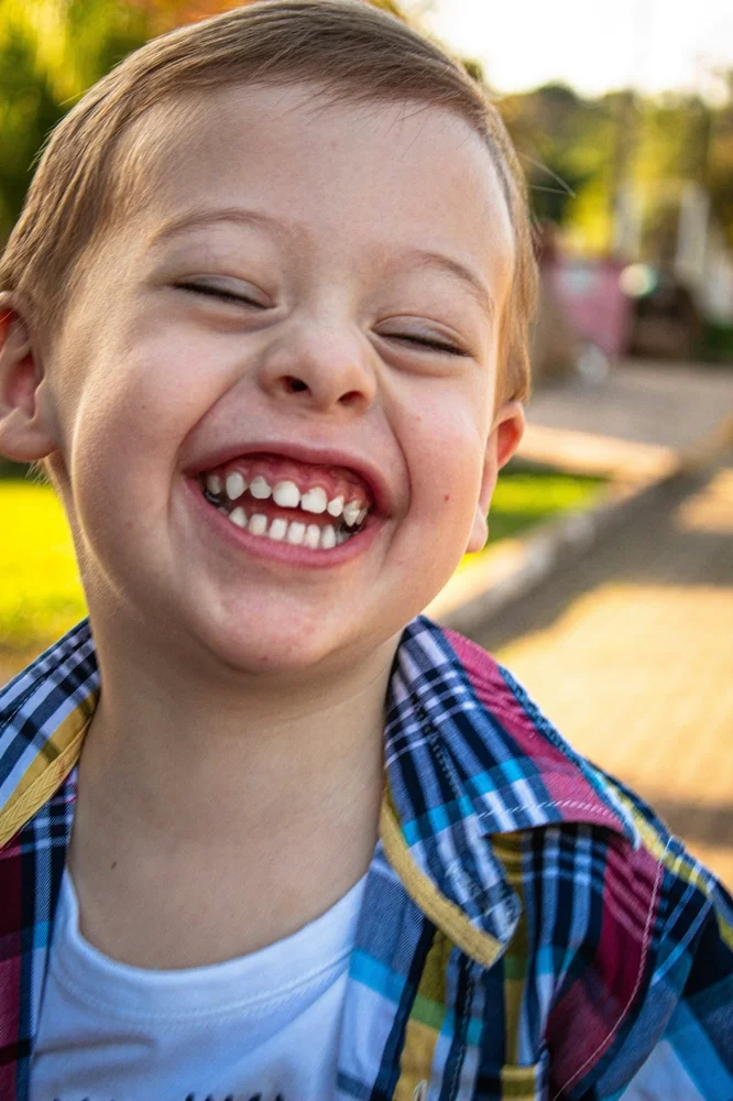 Child smiling. Photo by <a href='https://unsplash.com/@amanda_sofia_'>Amanda Sofia Pellenz</a> on <a href='https://unsplash.com/photos/YuidWzM37C0'>Unsplash</a>